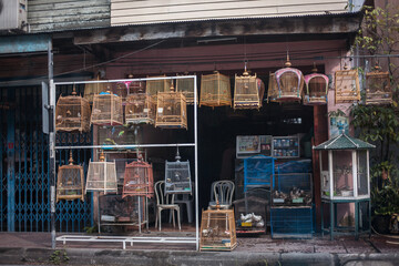 Bird Cage in front of  urban house in old town. It's  have been made for raising birds at home, decoration and trade