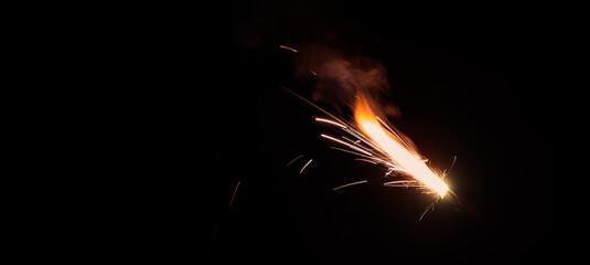Fototapeta na wymiar Burning flare or flame with bright sparks and smoke from a burnt candle on background with copy space. festive event concept.