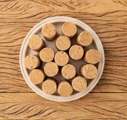 Pacoca, typical brazilian peanut candy and june festival food over wooden table