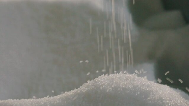 Falling polypropylene granules, slow motion. Polypropylene granules. Polypropylene granules close-up. Nonwoven Fabric Factory