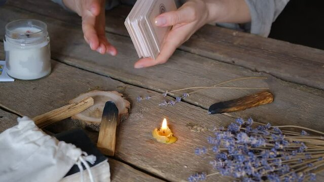 Tarot cards, Fortune telling on tarot cards magic crystal, occultism, Esoteric background. Fortune telling,tarot predictions.Fortune teller woman  tarot cards over white wooden table background.