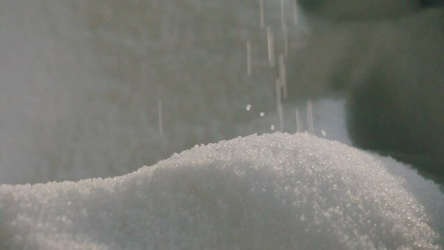 Polypropylene granules. Falling polypropylene granules, slow motion. Polypropylene granules close-up. Nonwoven Fabric Factory