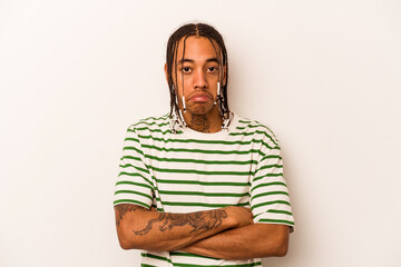 Young African American man isolated on white background shrugs shoulders and open eyes confused.