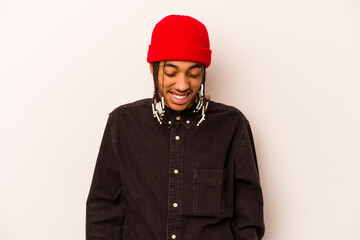 Young African American man isolated on white background laughs and closes eyes, feels relaxed and happy.