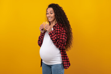 Funny Pregnant Latin Lady Holding Burger Biting Sandwich At Studio