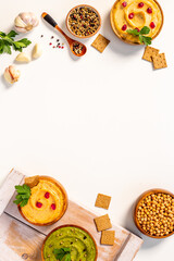 Flatlay of vegetarian hummus in bowls with chickpeas