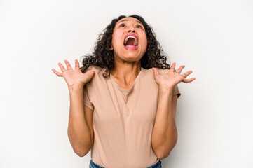 Young hispanic woman isolated on white background screaming to the sky, looking up, frustrated.
