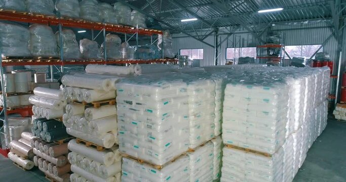 Warehouse of raw materials at the factory. Lots of raw material bag for production. Spunbond in rolls in the warehouse of the factory
