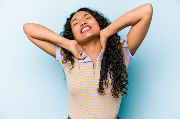Young hispanic woman isolated on blue background suffering neck pain due to sedentary lifestyle.
