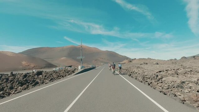 Group of cyclist riding bikes all together in the middle of the road having fun and enjoying summer and free time. Having healthy lifestyle concept outdoors