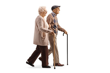 Elderly man and woman walking together with canes