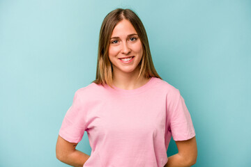 Obraz premium Young caucasian woman isolated on blue background happy, smiling and cheerful.