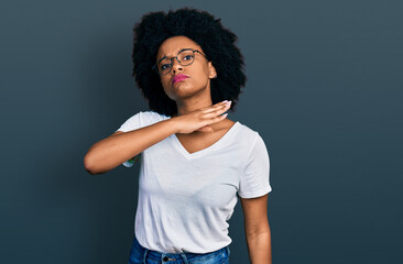 Young african american woman wearing casual white t shirt cutting throat with hand as knife,...