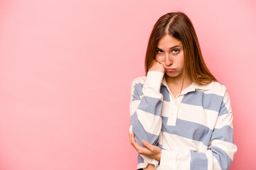 Young caucasian woman isolated on pink background who feels sad and pensive, looking at copy space.