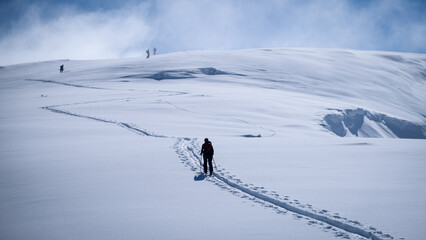 Ski touring skiers in Bucegi Mountains on a beautiful sunny day