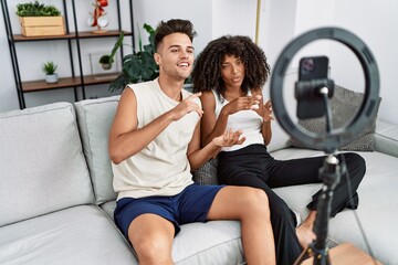 Man and woman couple using smartphone having video call at home