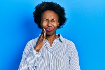 Fototapeta na wymiar Young african american woman wearing casual clothes touching mouth with hand with painful expression because of toothache or dental illness on teeth. dentist