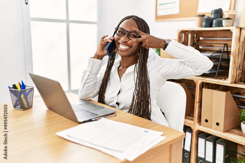 Sticker black woman with braids working at the office speaking on the phone doing peace symbol with fingers 