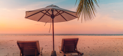 Beautiful panoramic beach. Chairs umbrella sandy beach, palm leaves seascape. Summer holiday vacation tourism. Amazing tropical landscape. Tranquil scenery, relaxing beach, tropical landscape panorama