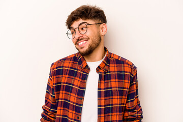 Young hispanic man isolated on white background laughs and closes eyes, feels relaxed and happy.