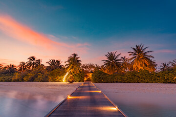 Sunset on Maldives island, luxury water villas resort, closeup wooden pier. Amazing colorful sky...