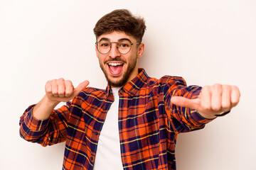 Young hispanic man isolated on white background raising both thumbs up, smiling and confident.