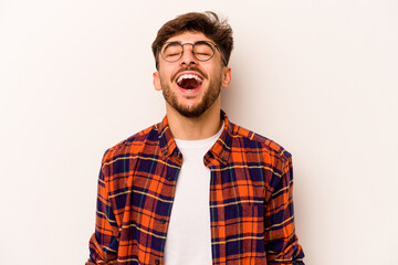 Fototapeta premium Young hispanic man isolated on white background relaxed and happy laughing, neck stretched showing teeth.