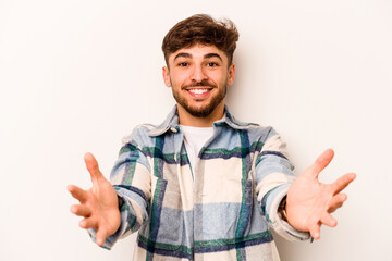 Young hispanic man isolated on white background showing a welcome expression.