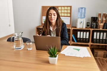 Young hispanic woman business worker using laptop working at office
