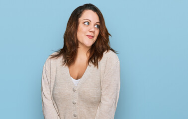 Obraz premium Young plus size woman wearing casual clothes smiling looking to the side and staring away thinking.