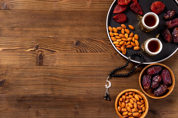 Ramadan holyday table with dates fruits and islamic rosary with star and crescent