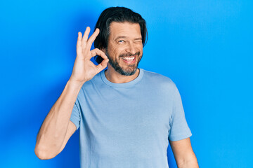 Middle age caucasian man wearing casual clothes smiling positive doing ok sign with hand and fingers. successful expression.