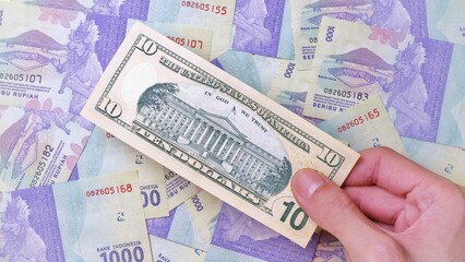 Man's hand is making a payment. Business Investment Economy Money Loan Saving Income Prosperity and Finance concept. Male hand showing dollar bills. Ten Dollar. 10 US Dollar. Money background.