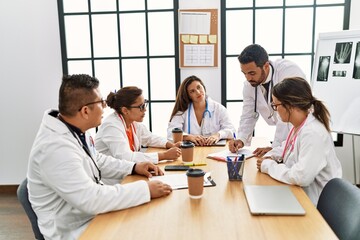 Group of hispanic doctor discussing in a medical meeting at the clinic office.