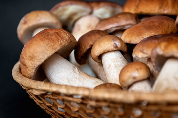 wicker basket full of fresh porcini mushrooms ready for cooking
