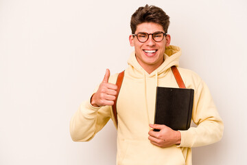 Young student caucasian man isolated on white background smiling and raising thumb up