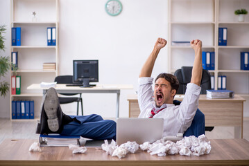 Young male employee in brainstorming concept