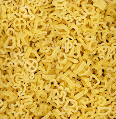 Pasta, macro view. Vermicelli or spaghetti in the form of small letters and numbers. A high resolution.