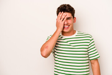 Young caucasian man isolated on white background laughing happy, carefree, natural emotion.