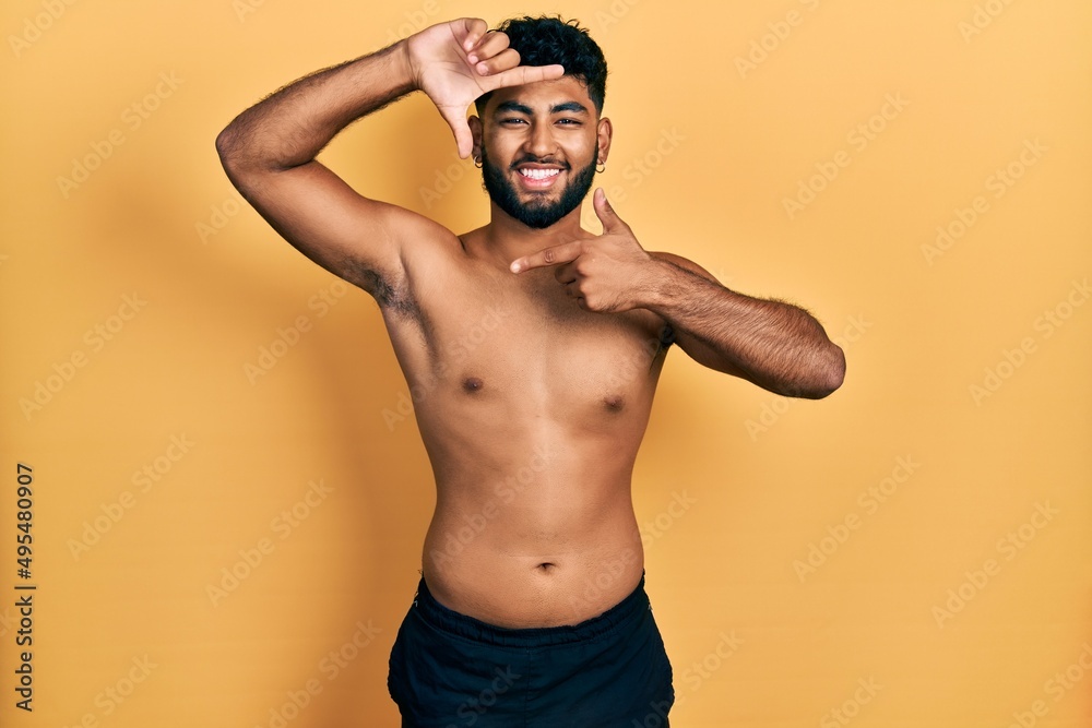 Sticker arab man with beard wearing swimwear shirtless smiling making frame with hands and fingers with happ