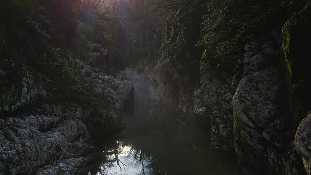 Flying over a river through a narrow canyon with white rocks, Sochi. Devils gate