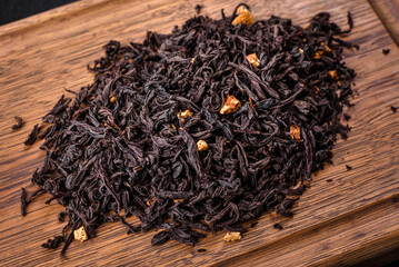Black Ceylon tea - Top view of black tea background with green leaves