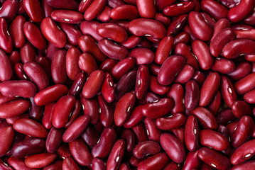 Beans of red dry raw beans on a dark concrete background