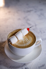 cappuccino with sweet marmalade on the background