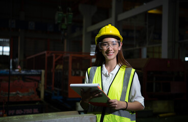 The female manager works in the audit field. She working to check the quality of work in heavy...