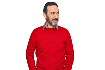 Middle age hispanic man wearing casual clothes smiling looking to the side and staring away thinking.