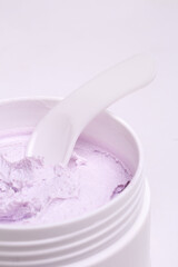 White jar with face cream close-up on a white background