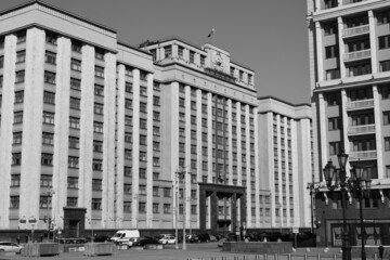 Black and white photography. View of the building of the State Duma in Moscow. Above the entrance there is an inscription in Russian STATE DUMA. March 24, 2022, Moscow, Russia.