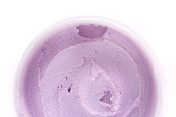 top view of a white jar of pink textured cream close-up