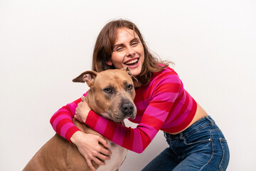 Young caucasian woman with her dog isolated on white background